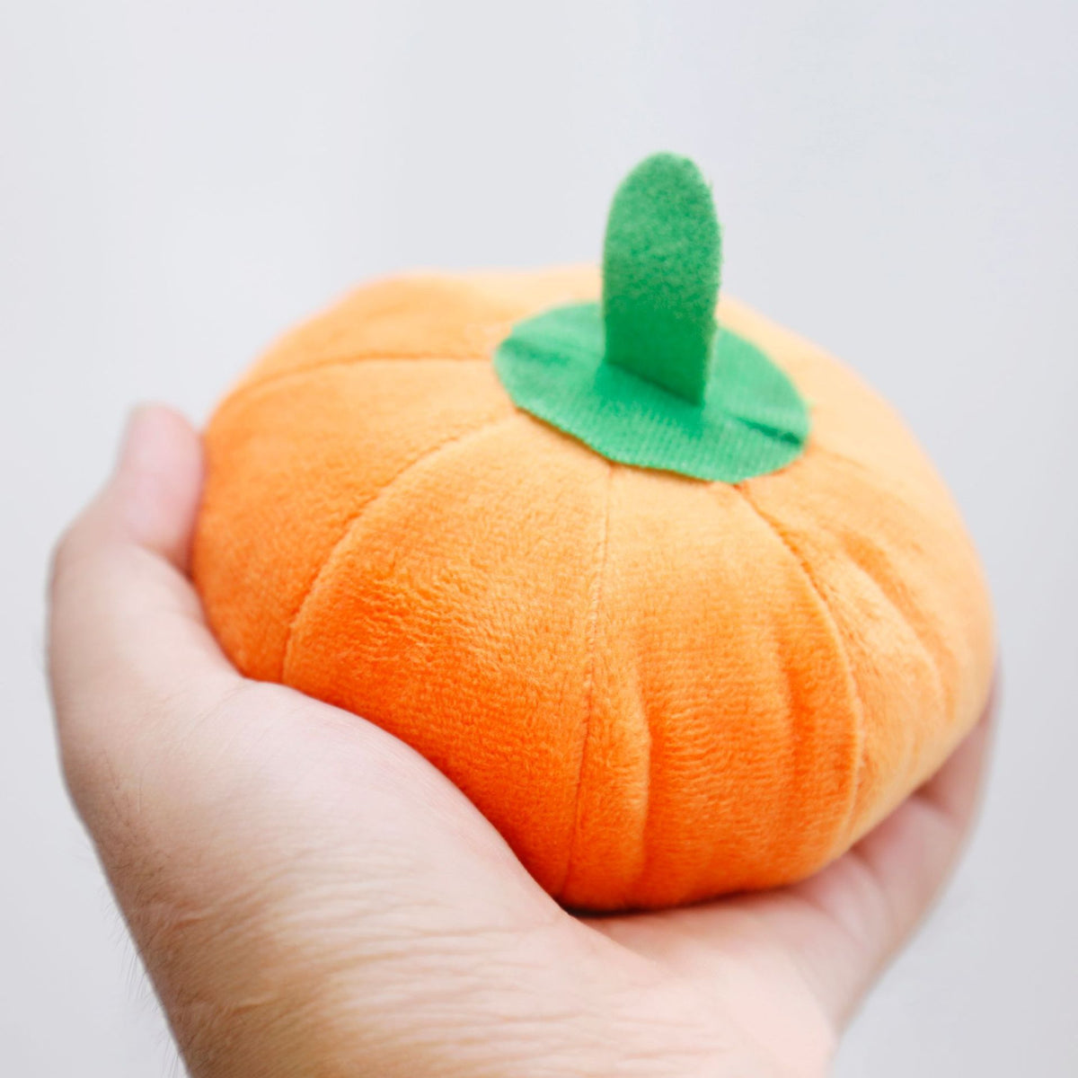 Small squeaky orange pumpkin plush dog toy, view 4